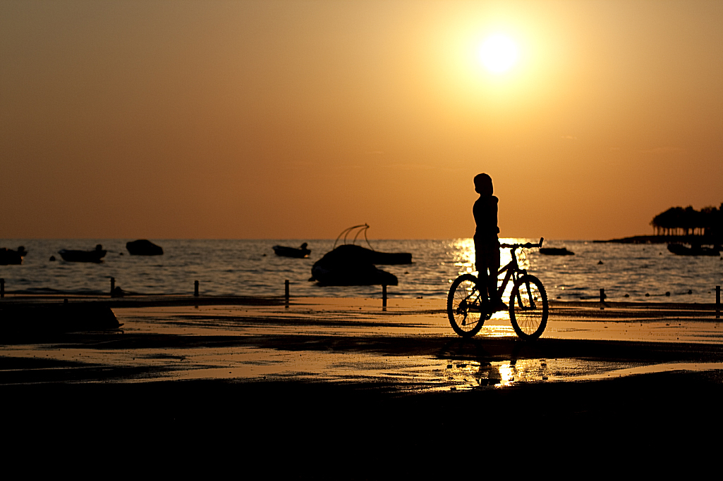 Solnedgang dreng på cykel